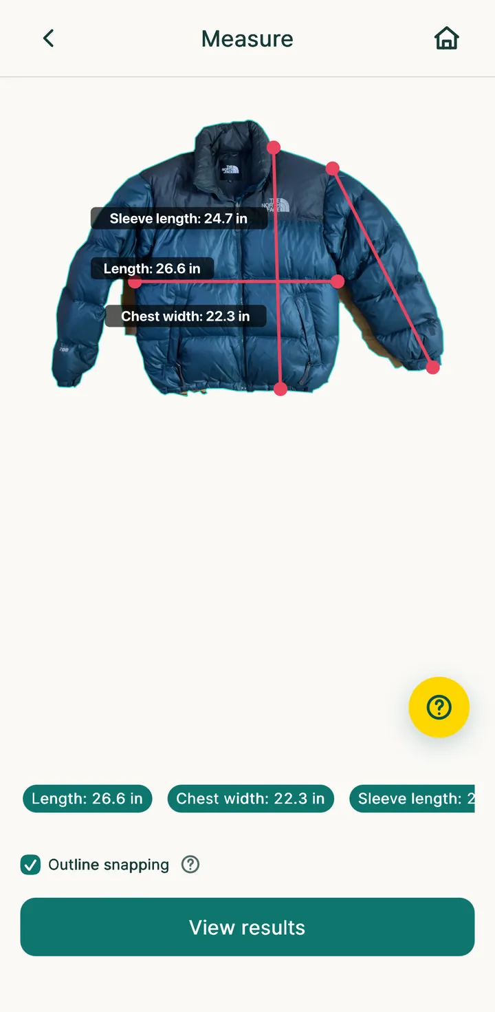 Measure screen: length, chest and sleeve lines drawn over a puffer jacket photo
